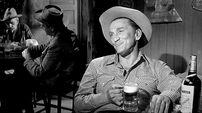 Kirk Douglas seated with drink
